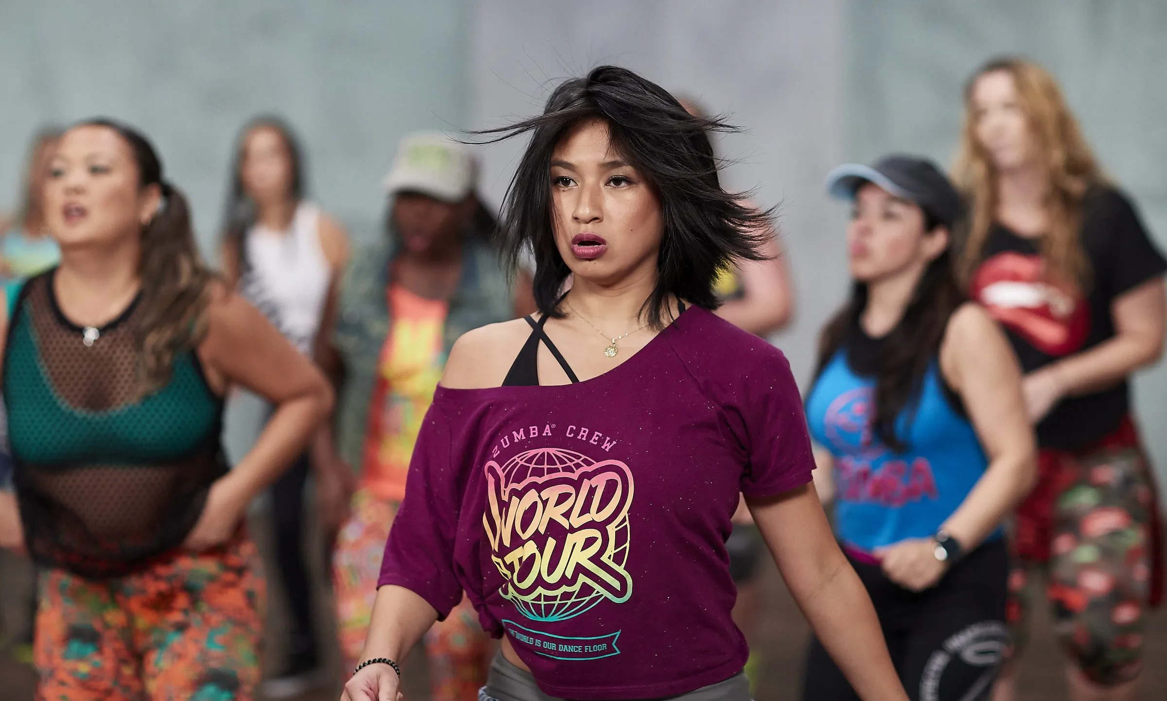 Gab leading a Zumba World Tour class, hair in motion